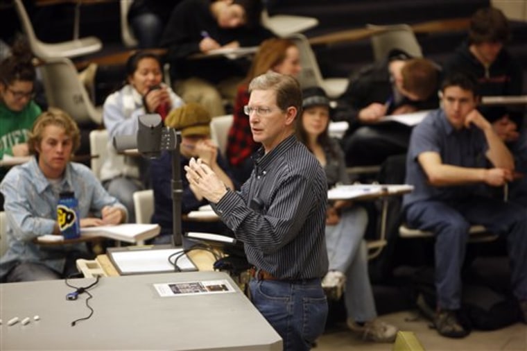 In this photograph taken on Friday, Feb. 26, 2010, students listen in the physics class of Professor Michael Dubson at the University of Colorado in Boulder, Colo. Some professors like Dubson endorse simple, straightforward devices that stick to multiple choice questions. Others embrace fancier models or newer applications for smart phones and laptops that allow students to query the professor by text or e-mail during the lecture or conduct discussion with classmates _ without the cost of purchasing a clicker. (AP Photo/David Zalubowski)
